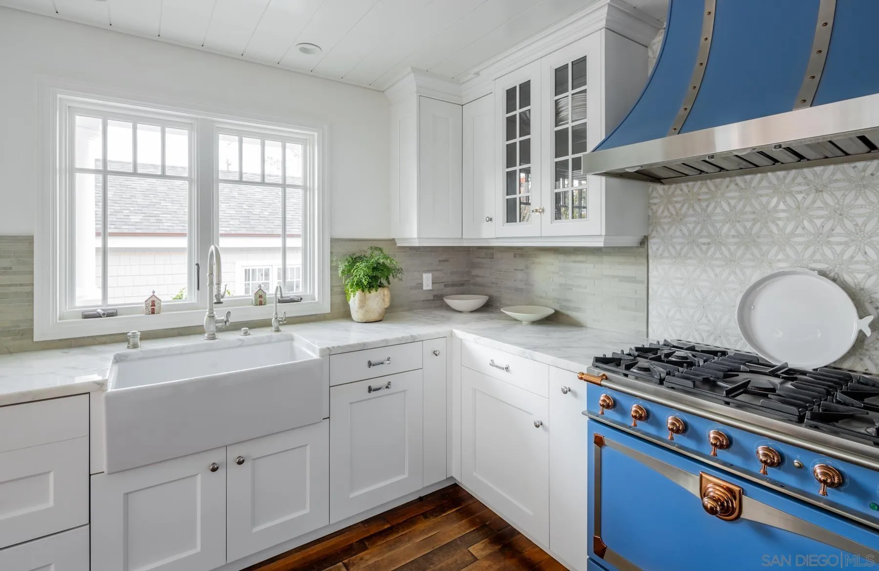 219 27th Street Del Mar, CA 92014 - Photo 20 of 47 a kitchen with a sink stove and cabinets