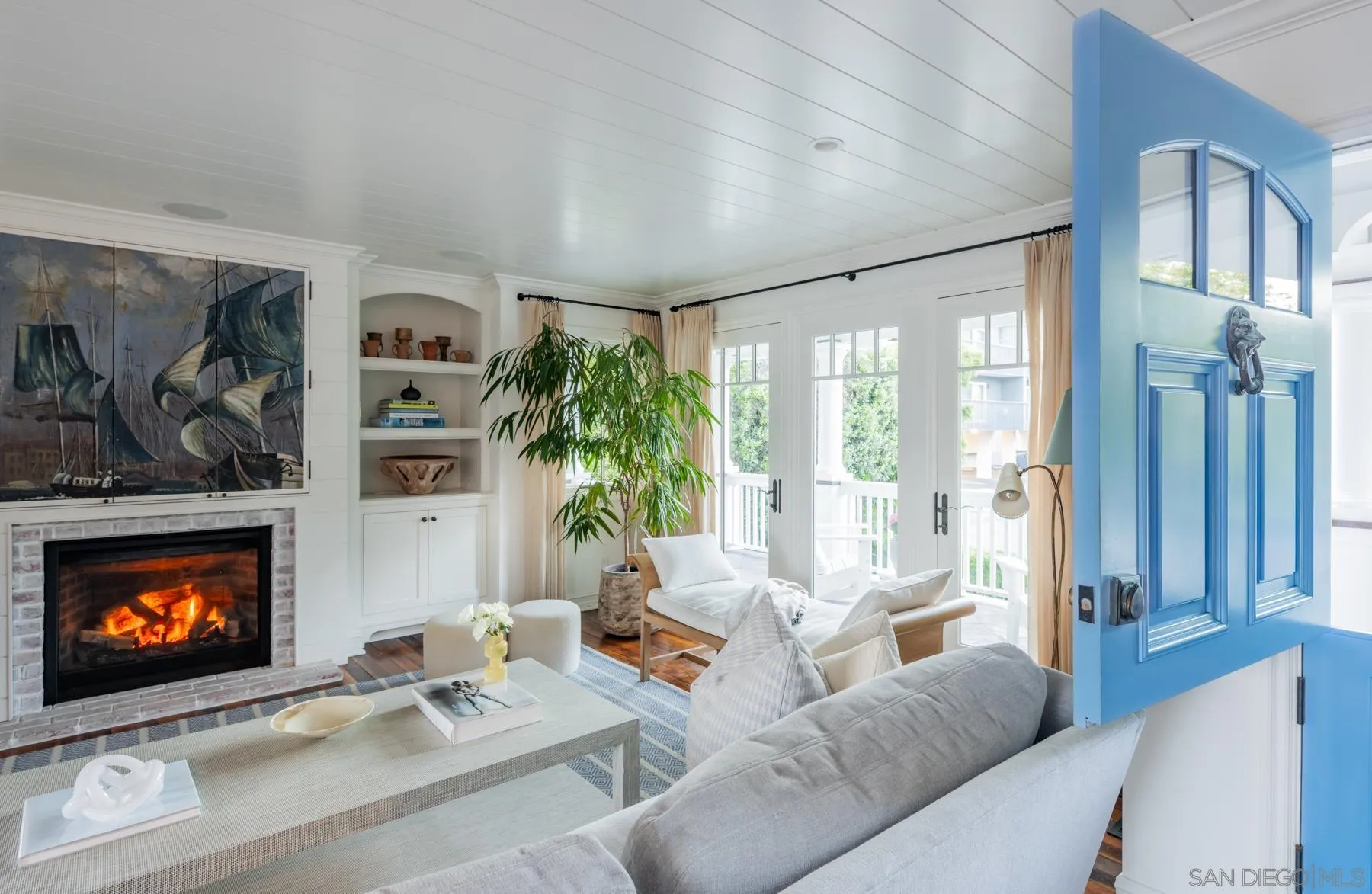 219 27th Street Del Mar, CA 92014 - Photo 8 of 47 a living room with furniture a fireplace and a floor to ceiling window