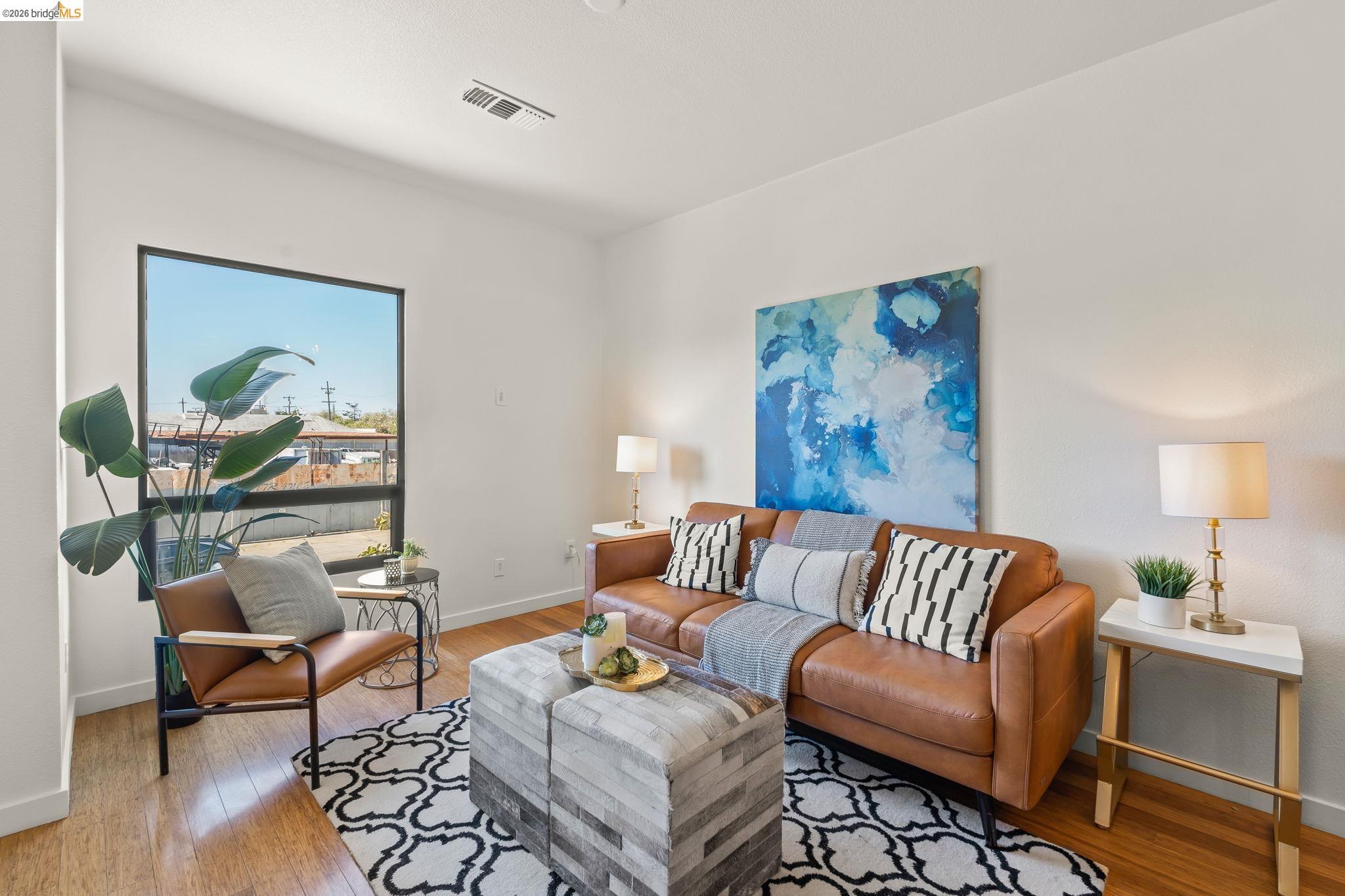 1780 12th Street Oakland, CA 94607 - Photo 11 of 31 a living room with furniture and a painting on the wall