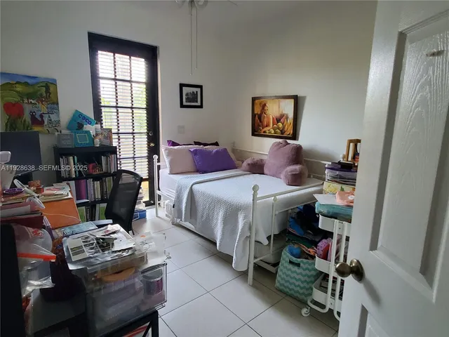 a bedroom with bed and a window