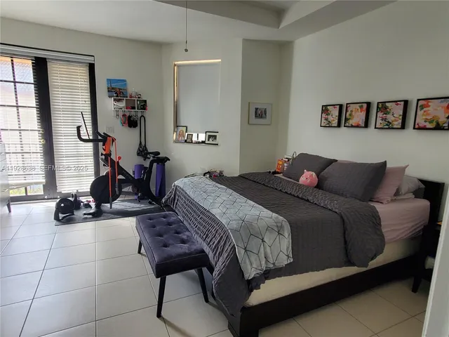 a bedroom with a bed and gym equipment