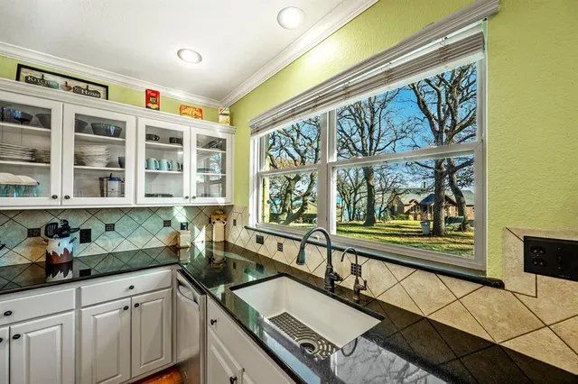 a kitchen with a sink and wooden cabinets