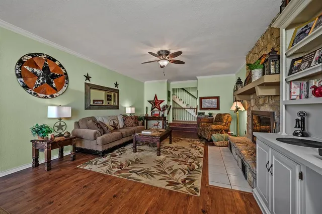 a living room with furniture and a book shelf