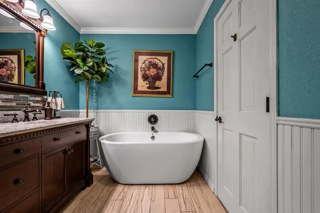 a spacious bathroom with a bathtub and a sink