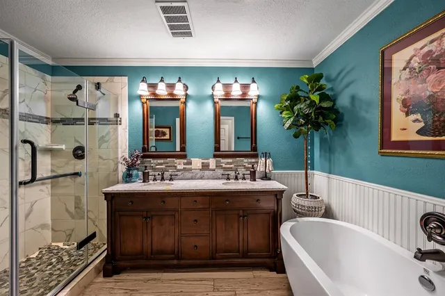 a spacious bathroom with a tub a sink and mirrors
