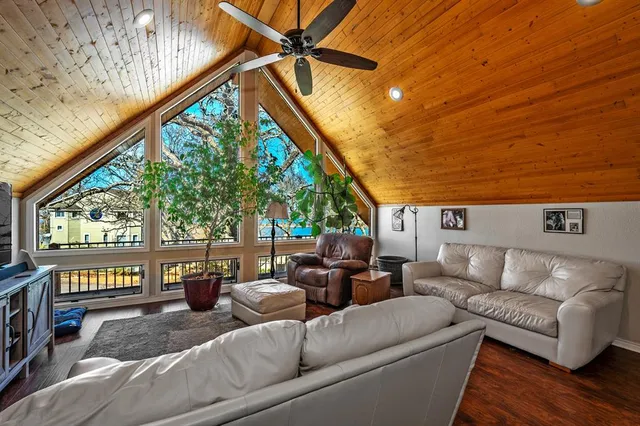 a living room with furniture and a floor to ceiling window