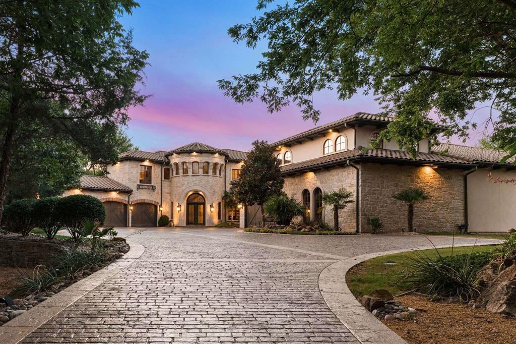2115 Paradise Rnch Trail McKinney, TX 75071 - Photo 40 of 40 Stone and stucco exterior featuring a grand arched entry, barrel tile roof, three-car garage, and a stamped concrete driveway