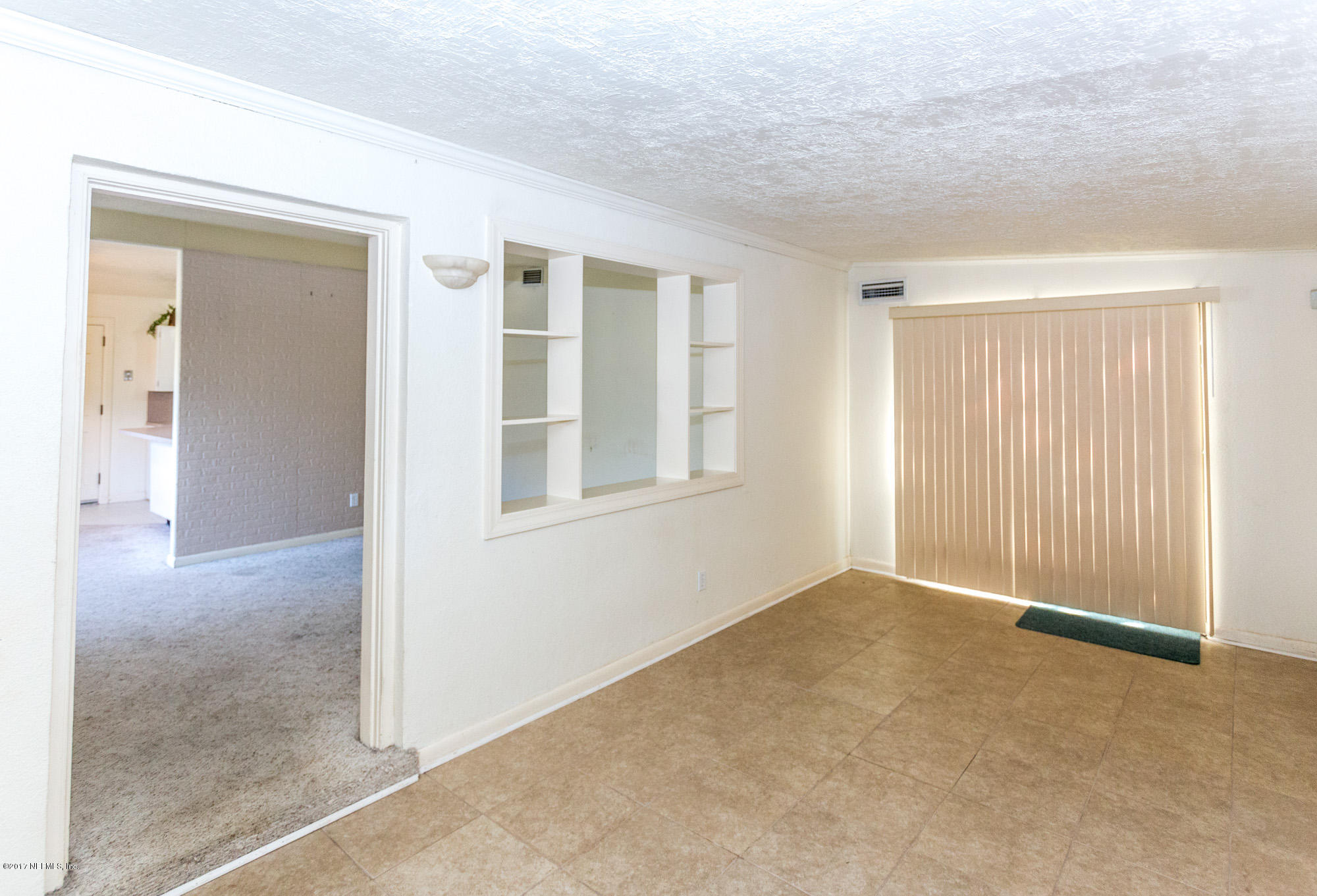 7010 Arques Road Jacksonville, FL 32205 - Photo 3 of 16 a view of an empty room with a window