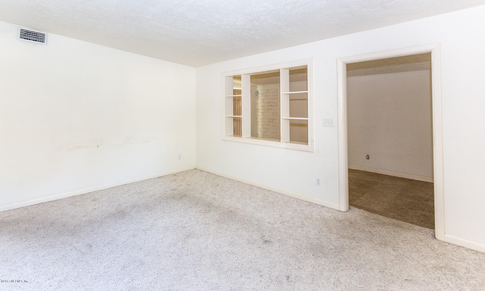 7010 Arques Road Jacksonville, FL 32205 - Photo 5 of 16 an empty room with windows