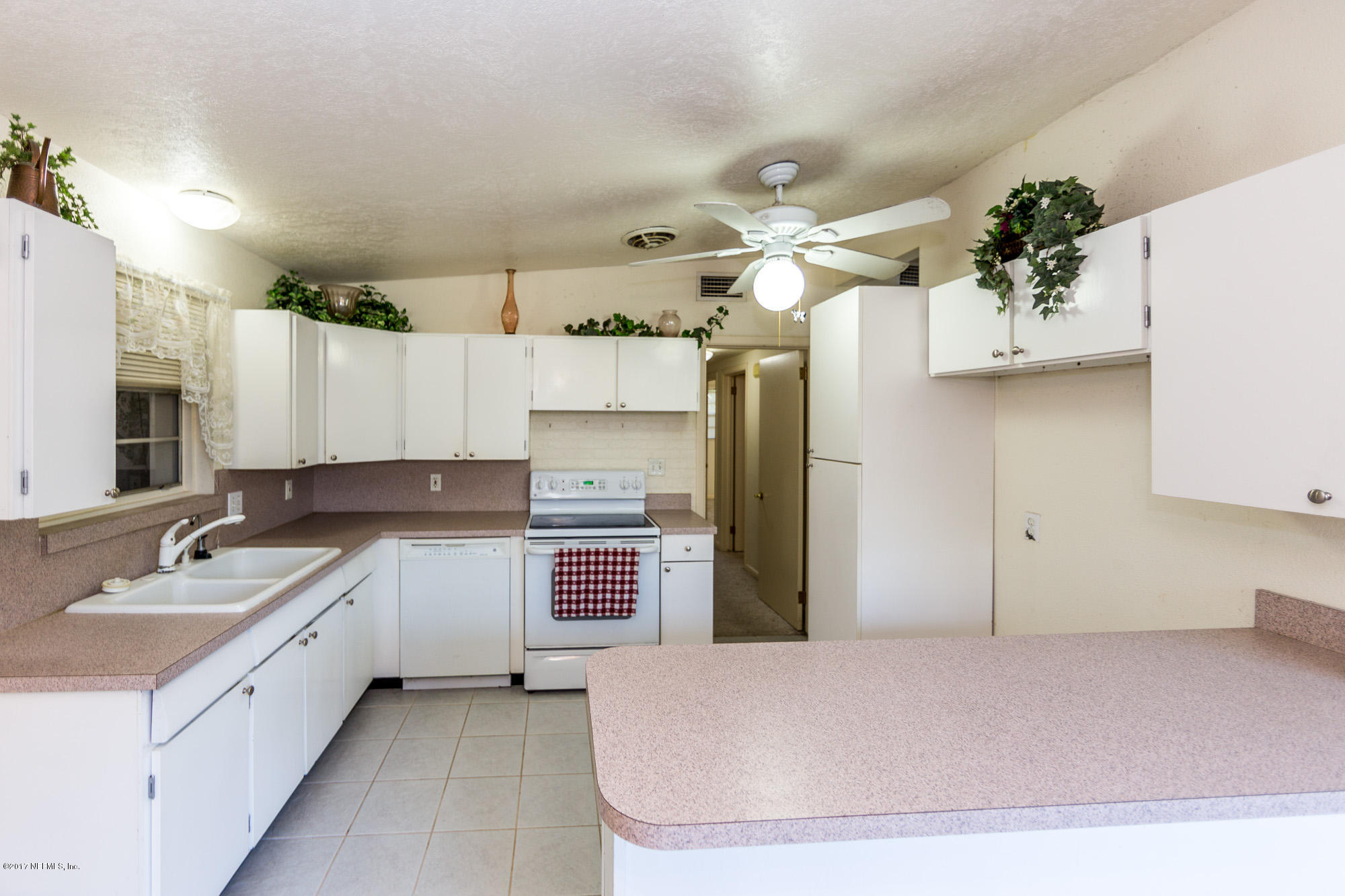 7010 Arques Road Jacksonville, FL 32205 - Photo 8 of 16 a large white kitchen with a refrigerator a sink and dishwasher