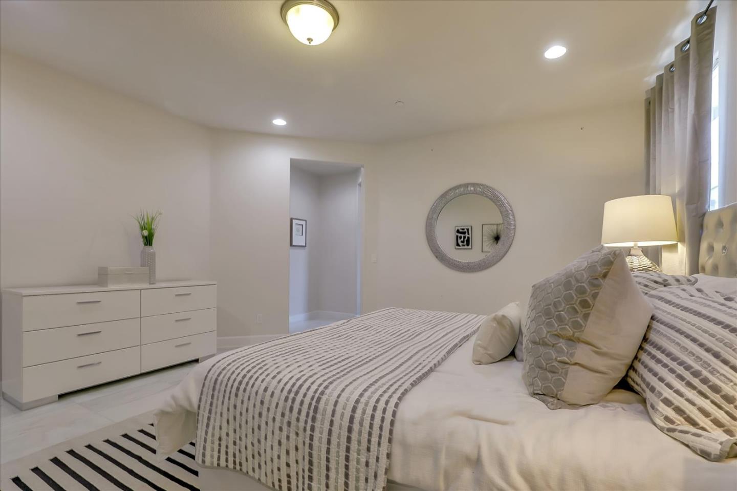 1081 Cabrillo Drive Hollister, CA 95023 - Photo 23 of 60 a bedroom with a bed and a lamp on dresser