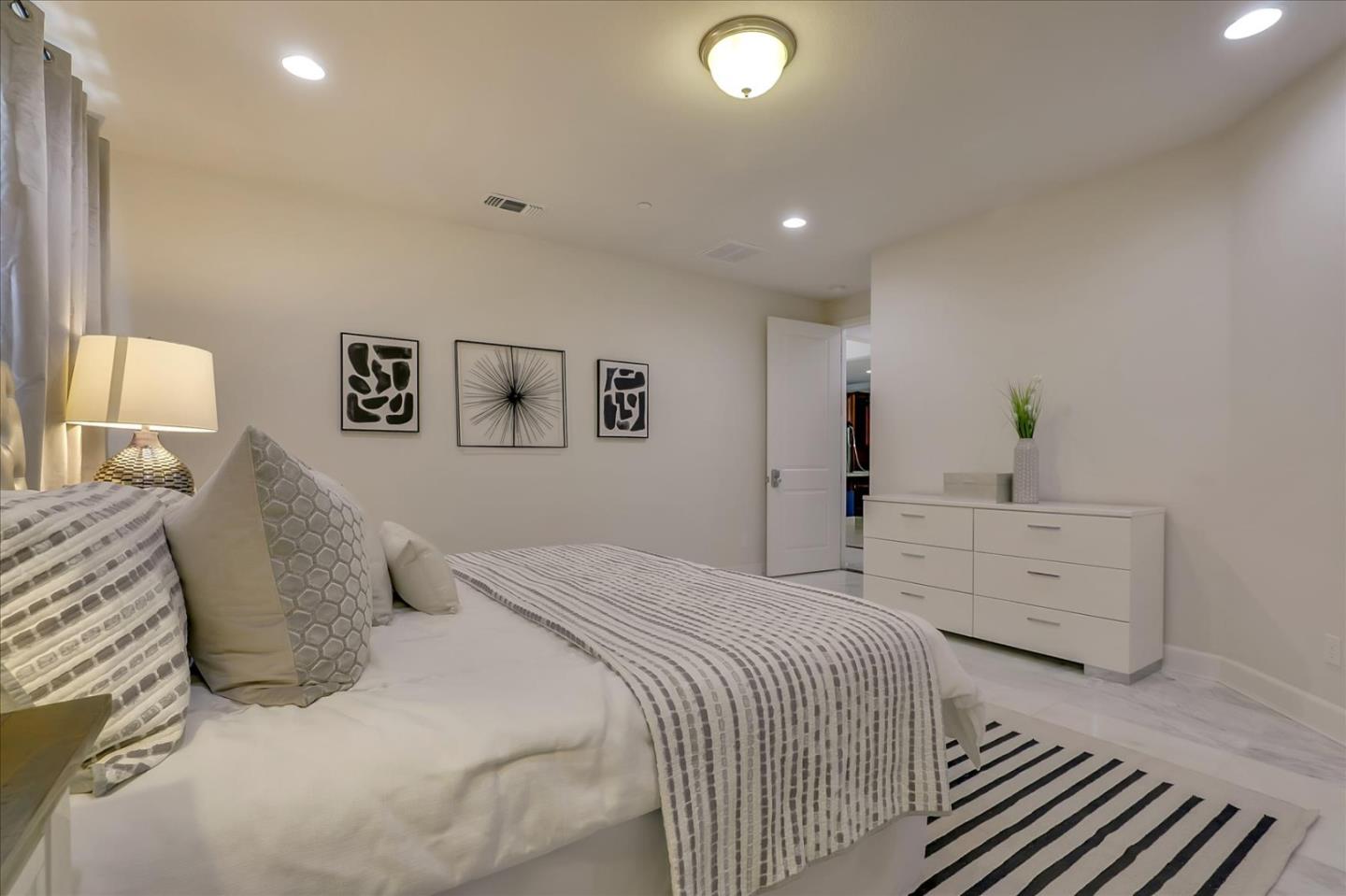 1081 Cabrillo Drive Hollister, CA 95023 - Photo 24 of 60 a spacious bedroom with a bed and a cabinets