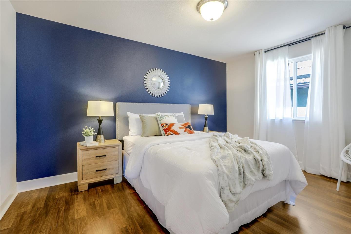 1081 Cabrillo Drive Hollister, CA 95023 - Photo 26 of 60 a bedroom with a bed and a chandelier