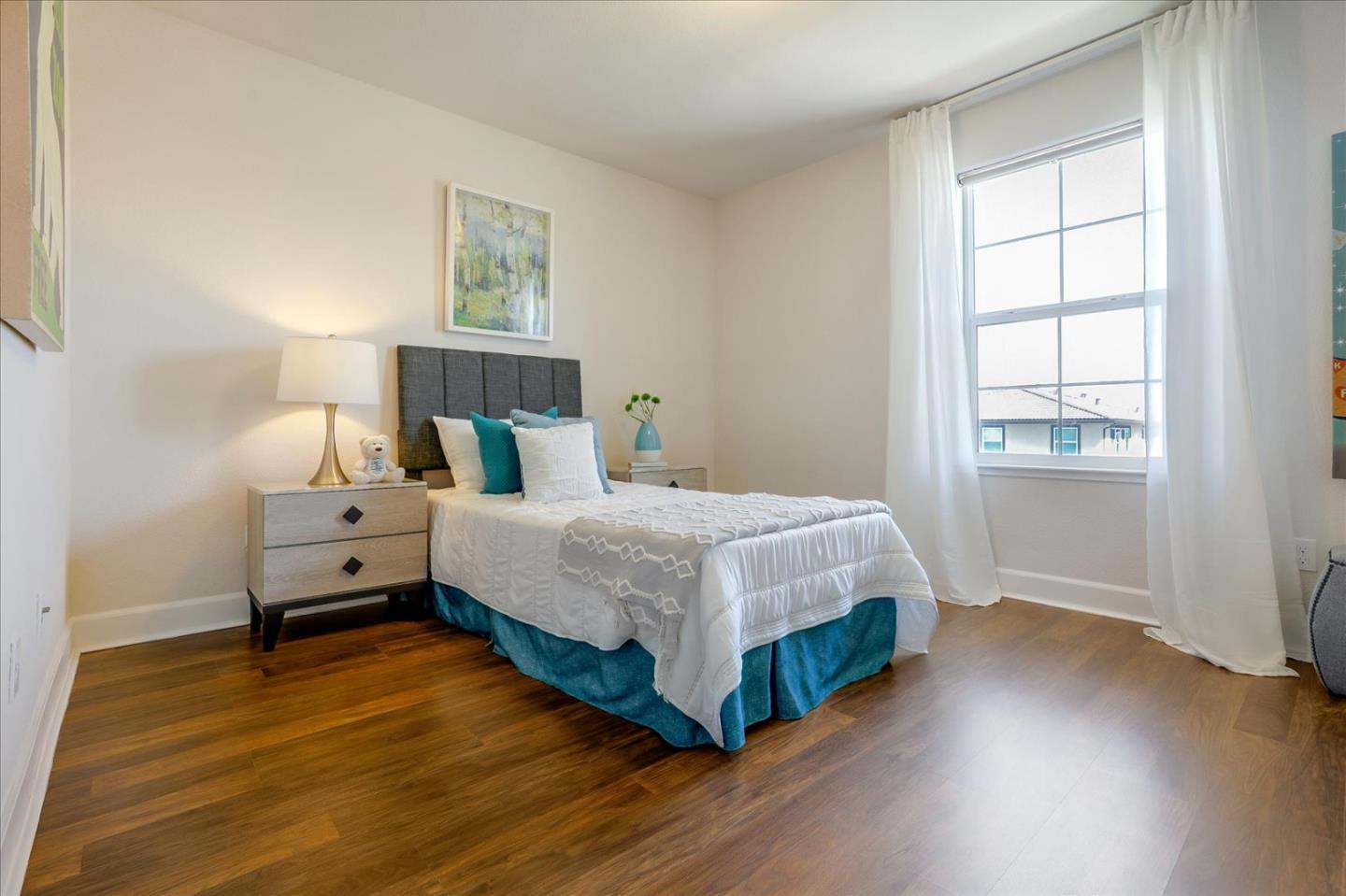 1081 Cabrillo Drive Hollister, CA 95023 - Photo 28 of 60 a bedroom with a bed and wooden floor