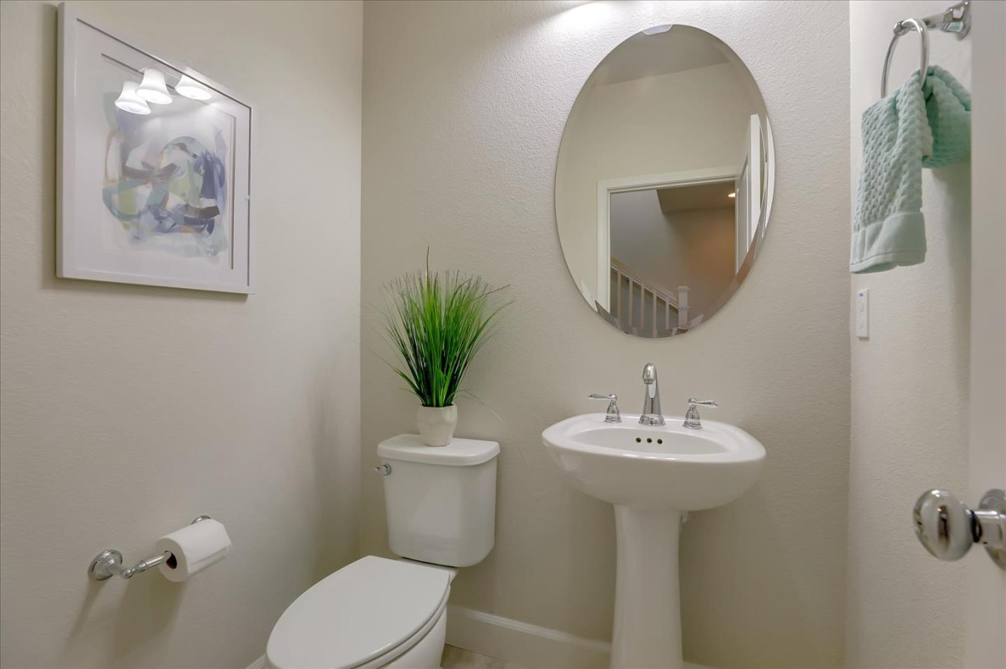 1081 Cabrillo Drive Hollister, CA 95023 - Photo 31 of 60 a bathroom with a toilet sink and mirror