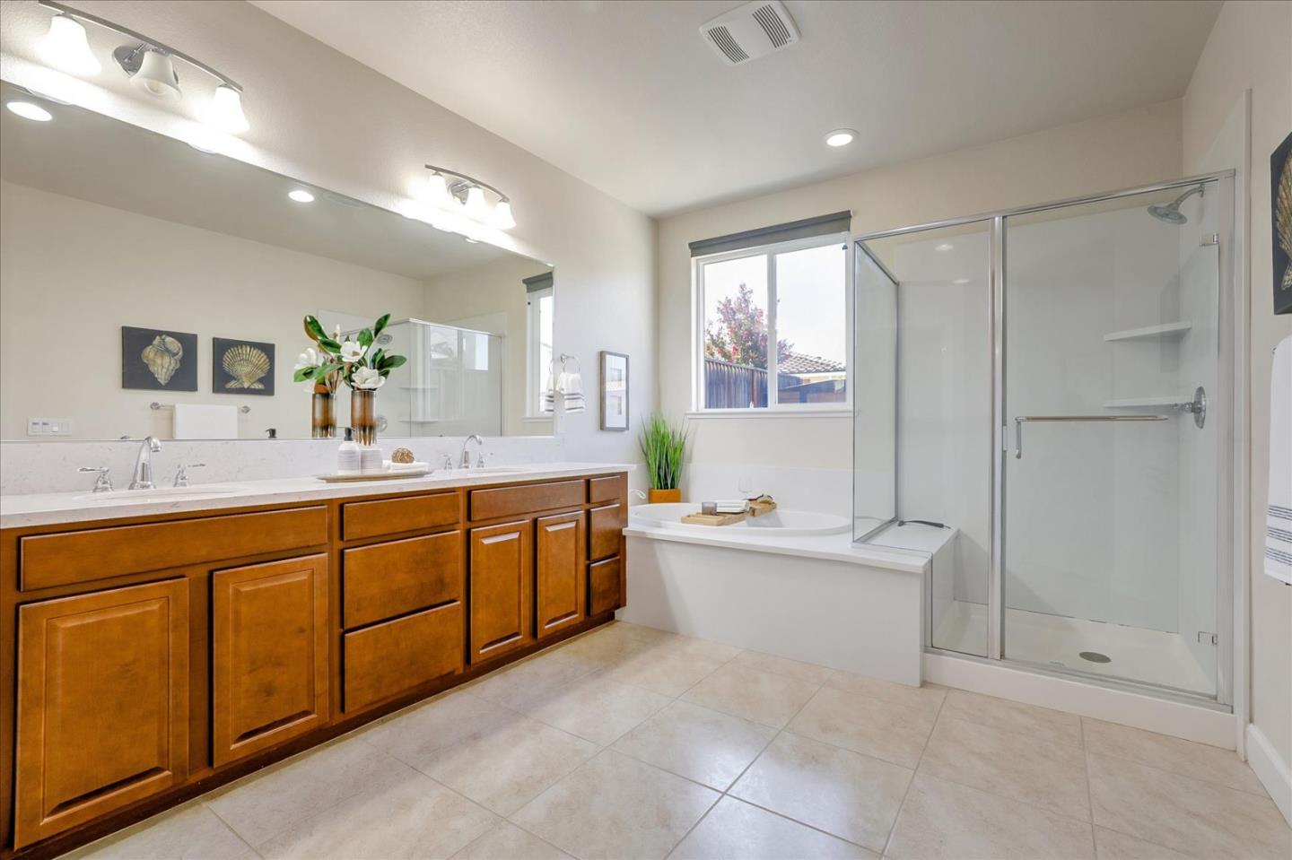 1081 Cabrillo Drive Hollister, CA 95023 - Photo 32 of 60 a spacious bathroom with a double vanity sink a large mirror and a bathtub