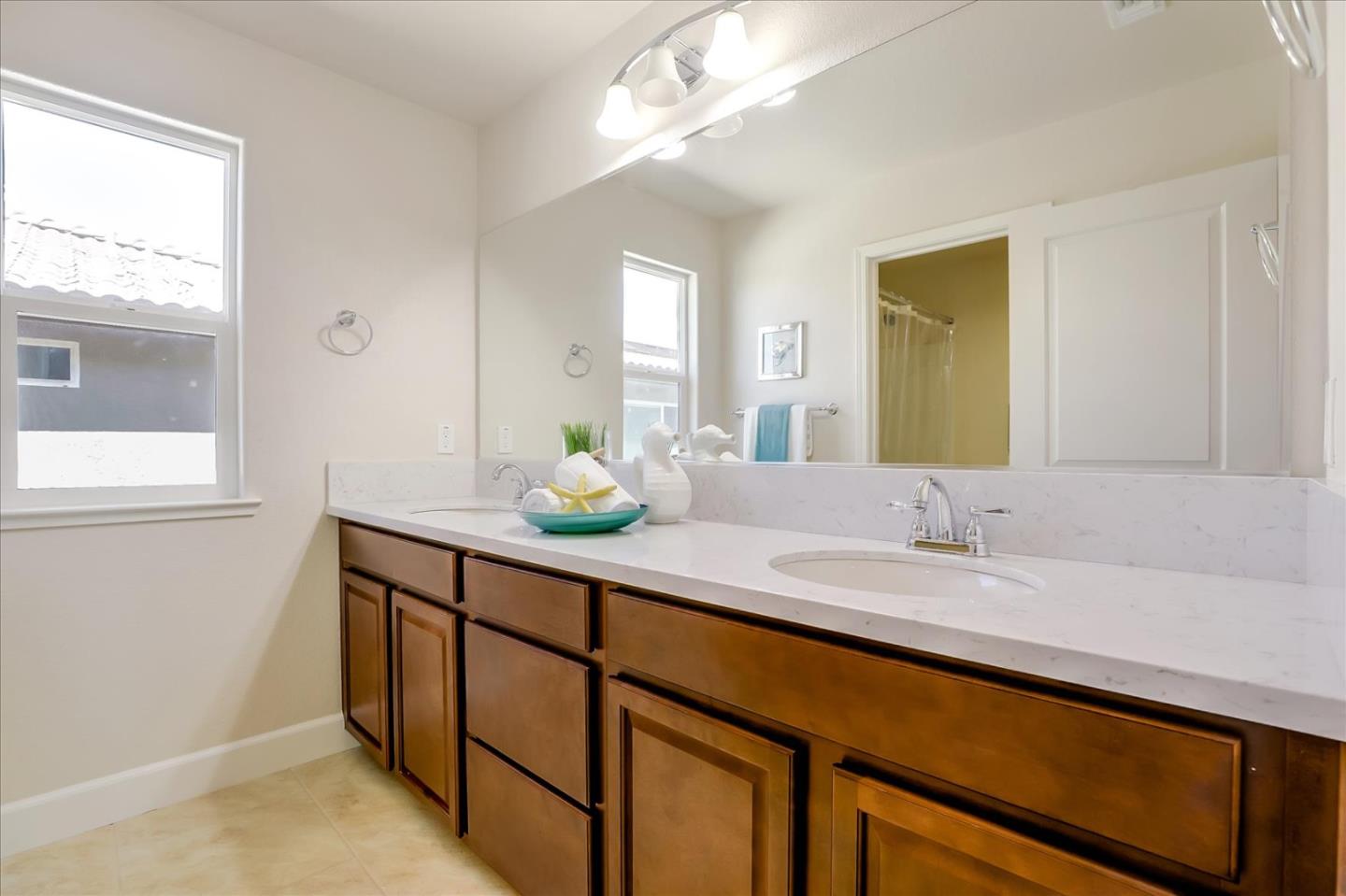 1081 Cabrillo Drive Hollister, CA 95023 - Photo 34 of 60 a bathroom with a granite countertop sink and a mirror