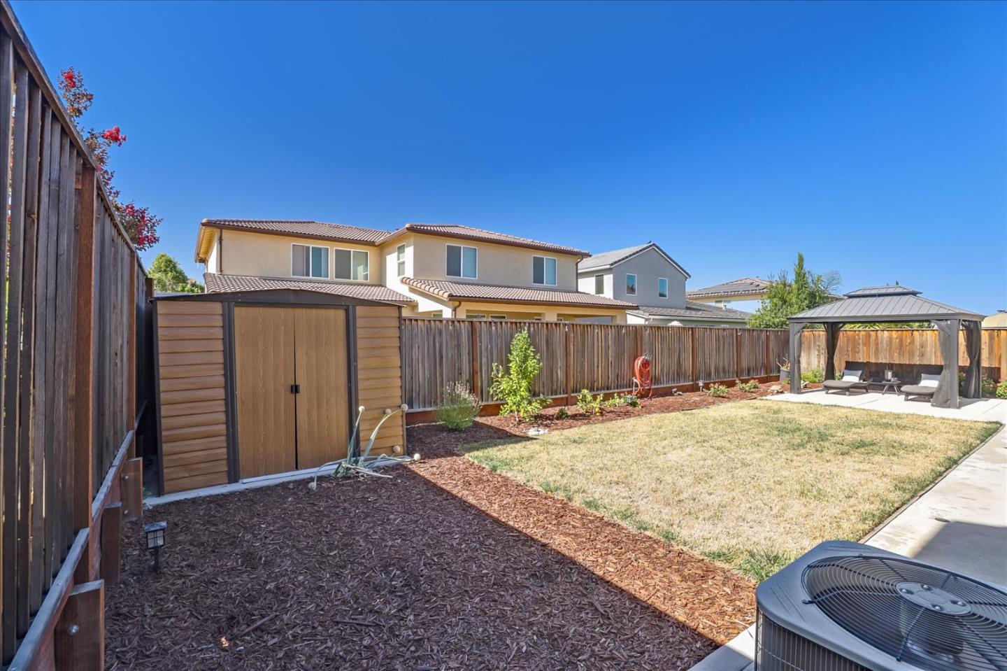 1081 Cabrillo Drive Hollister, CA 95023 - Photo 40 of 60 a front view of a house with yard and seating space