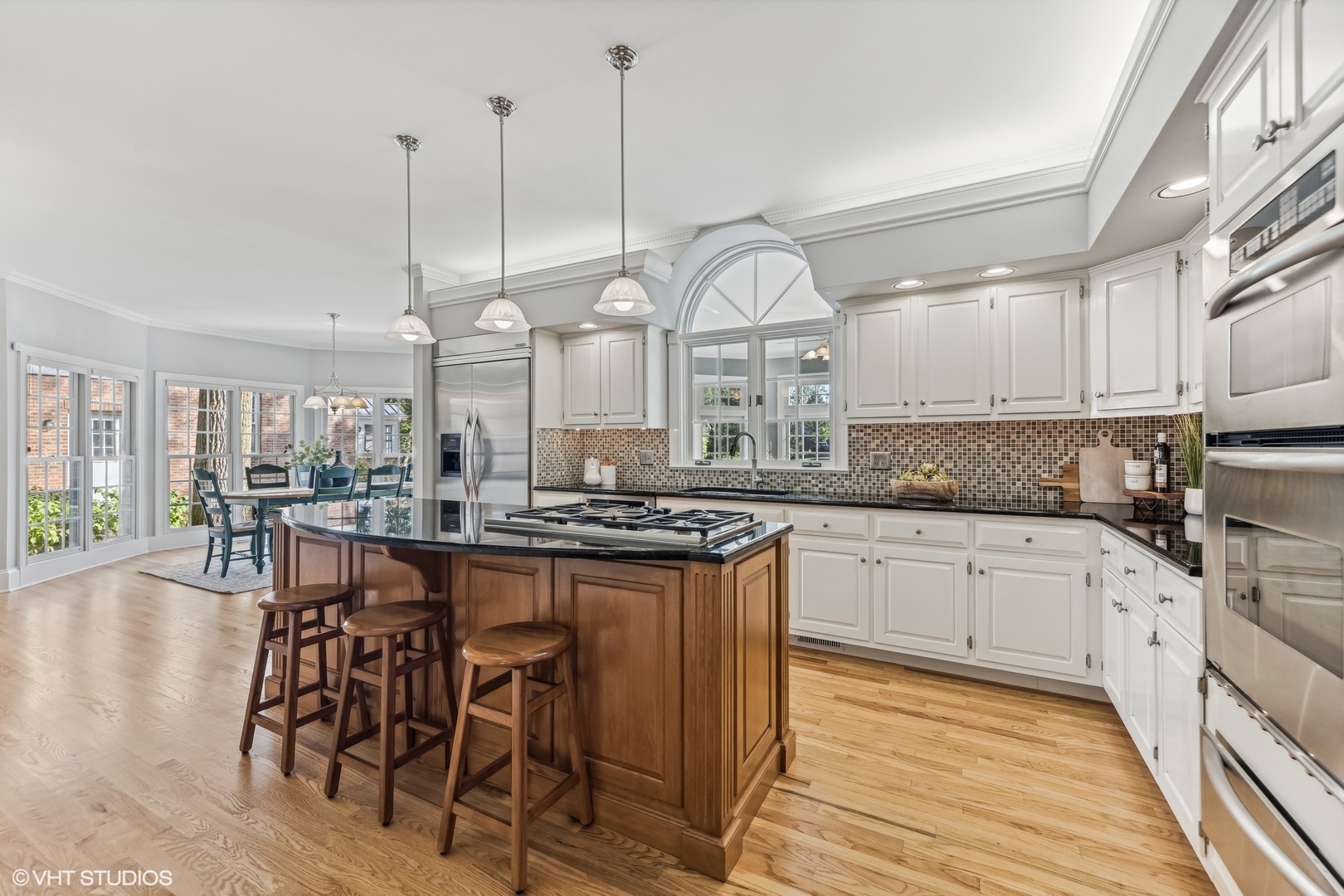 437 Stagecoach Run Glen Ellyn, IL 60137 - Photo 13 of 45 a kitchen with stainless steel appliances granite countertop a stove a sink dishwasher a dining table and chairs with wooden floor