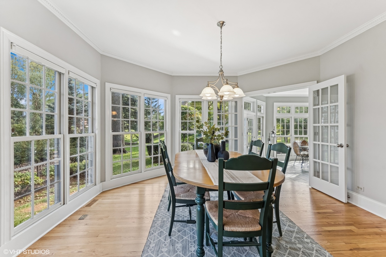 437 Stagecoach Run Glen Ellyn, IL 60137 - Photo 17 of 45 a view of a dining room with furniture large windows and wooden floor