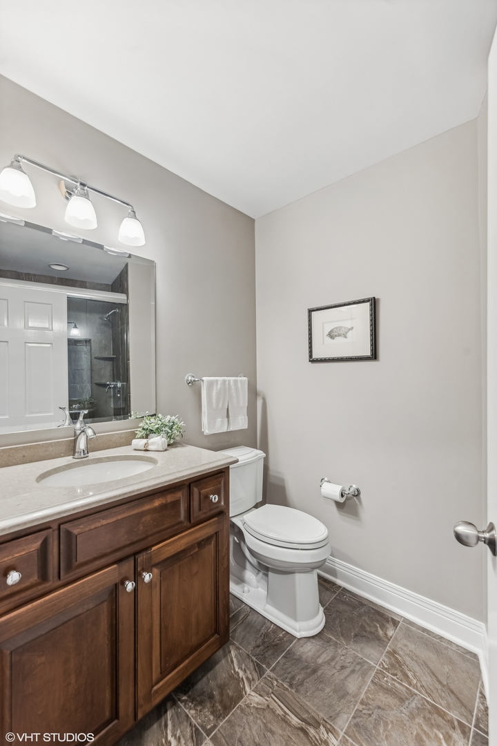437 Stagecoach Run Glen Ellyn, IL 60137 - Photo 30 of 45 a spacious bathroom with a sink and a toilet