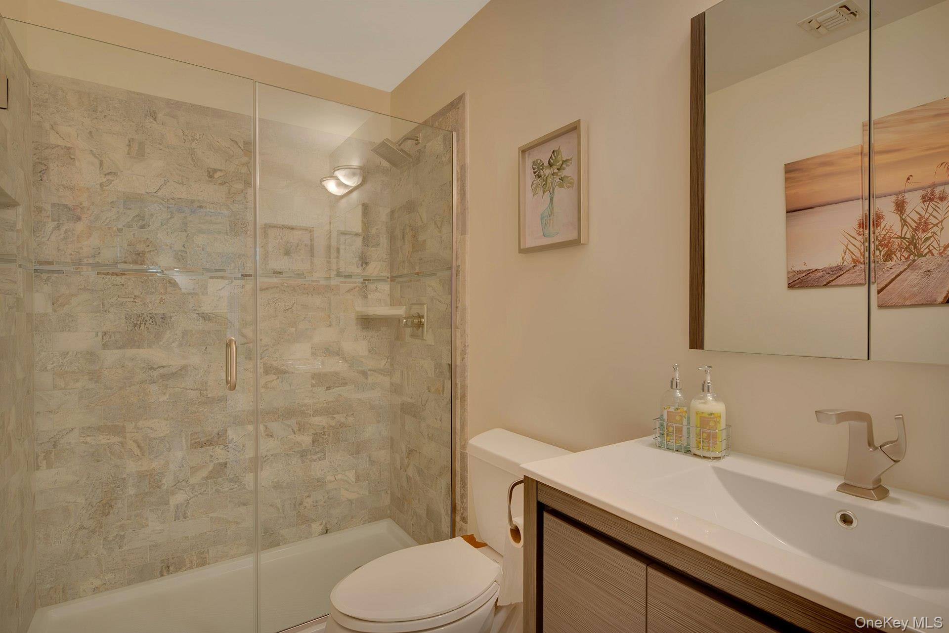 3045 Rocky Point Road East Marion, NY 11939 - Photo 12 of 22 a bathroom with a sink toilet and shower