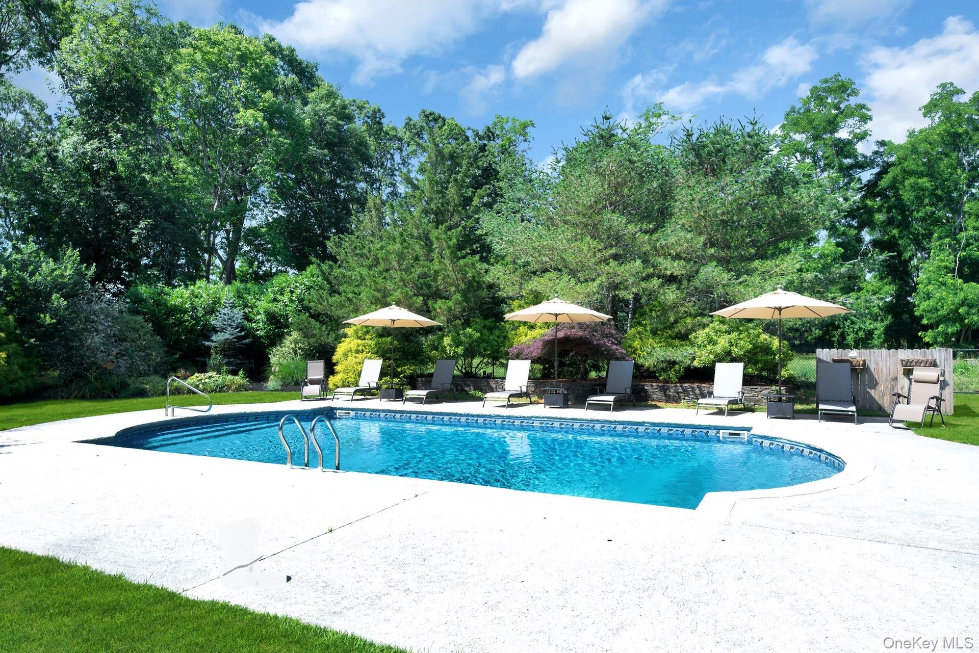 3045 Rocky Point Road East Marion, NY 11939 - Photo 19 of 22 a view of a swimming pool with lawn chairs and plants