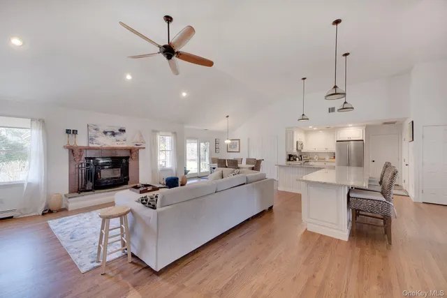 a living room with furniture a fireplace and a chandelier
