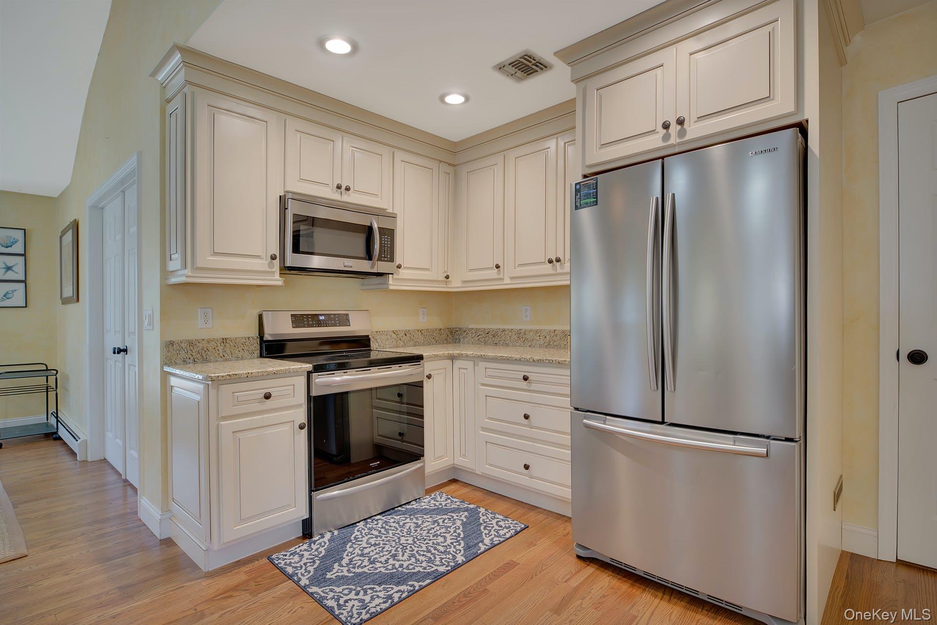 3045 Rocky Point Road East Marion, NY 11939 - Photo 5 of 22 a kitchen with stainless steel appliances a refrigerator stove and microwave