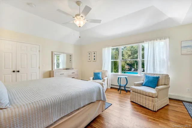 a bedroom with a bed ceiling fan and a window