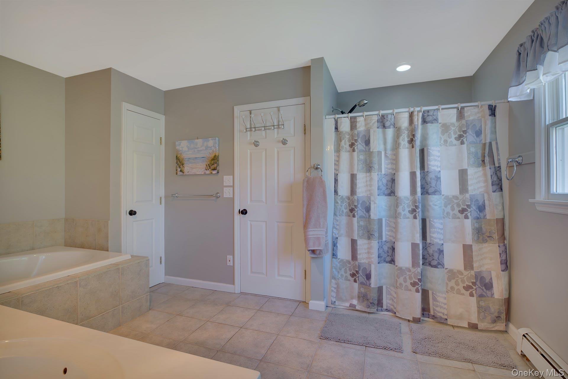 3045 Rocky Point Road East Marion, NY 11939 - Photo 8 of 22 a bathroom with a shower and a tub