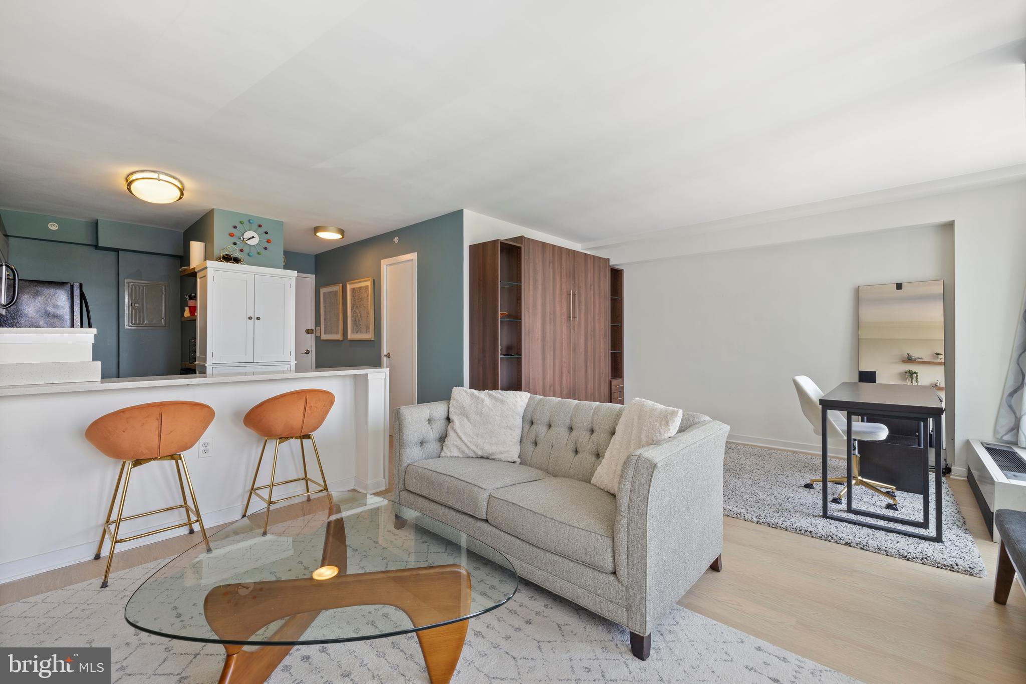 1101 3rd Street Southwest, Unit 705 Washington, DC 20024 - Photo 12 of 38 a living room with furniture and a dining table