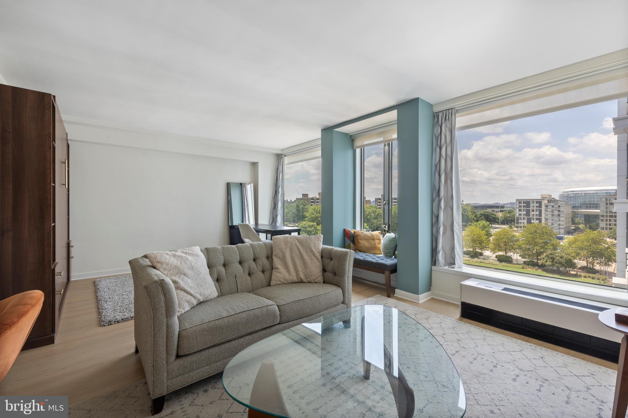 1101 3rd Street Southwest, Unit 705 Washington, DC 20024 - Photo 15 of 38 a living room with furniture and a large window