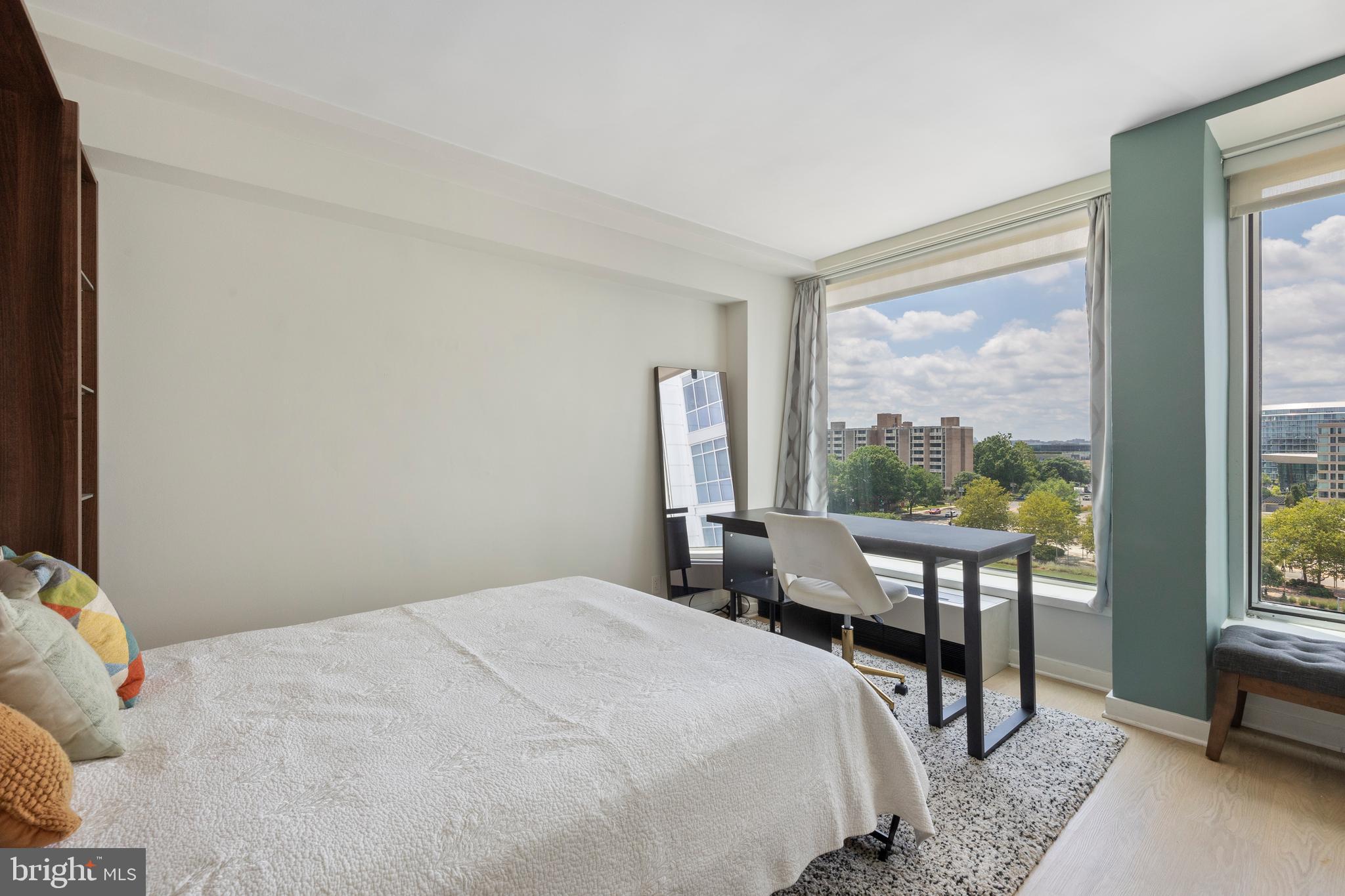 1101 3rd Street Southwest, Unit 705 Washington, DC 20024 - Photo 20 of 38 a bedroom with a bed and large windows