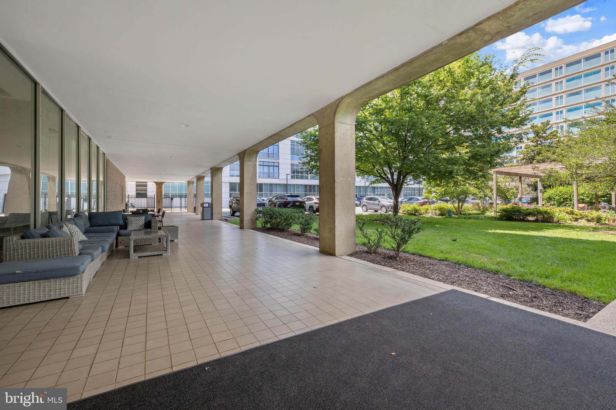 1101 3rd Street Southwest, Unit 705 Washington, DC 20024 - Photo 27 of 38 a view of a patio with couches and table and chairs next to yard