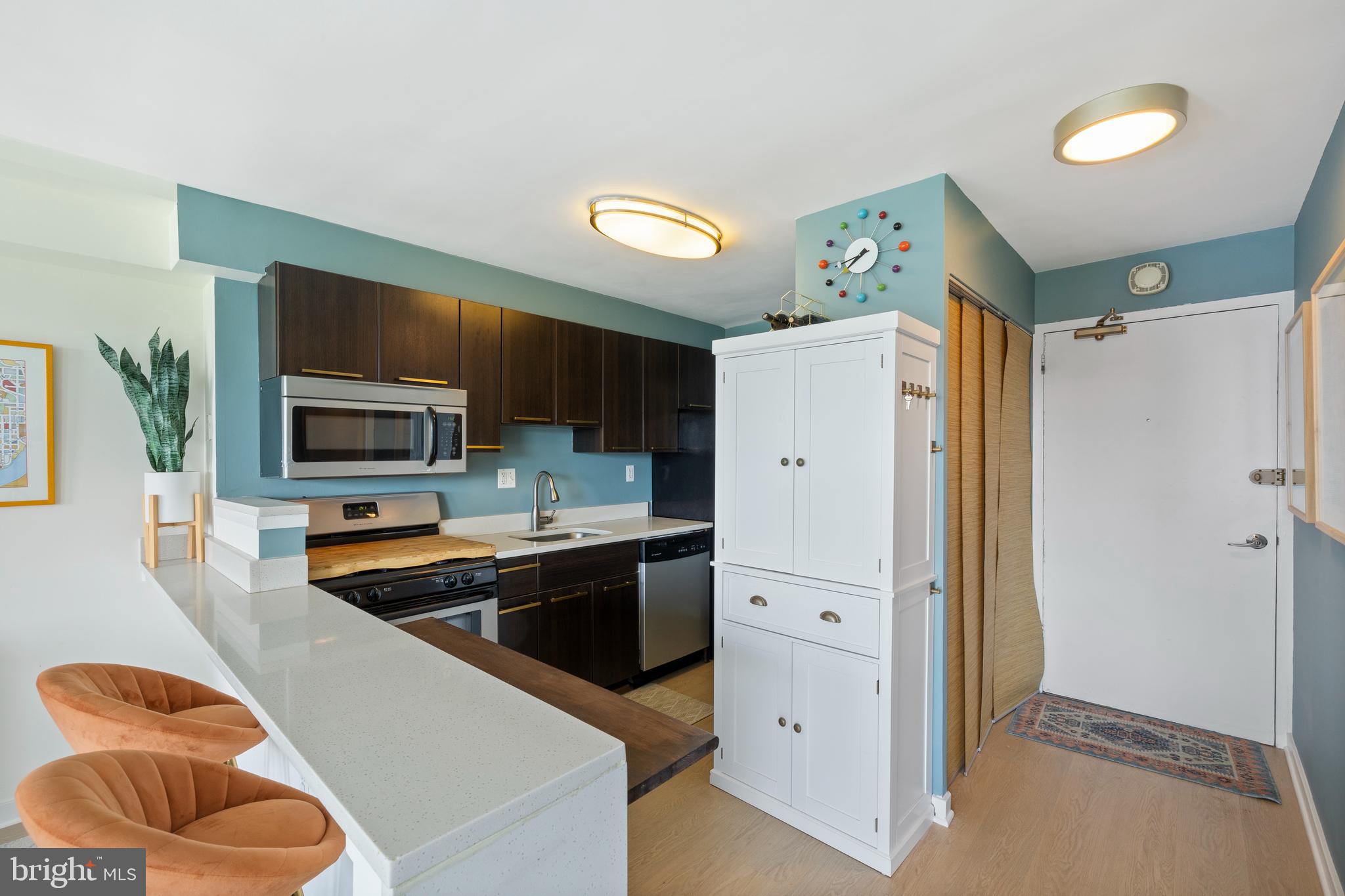 1101 3rd Street Southwest, Unit 705 Washington, DC 20024 - Photo 8 of 38 a kitchen with stainless steel appliances a refrigerator and a stove top oven