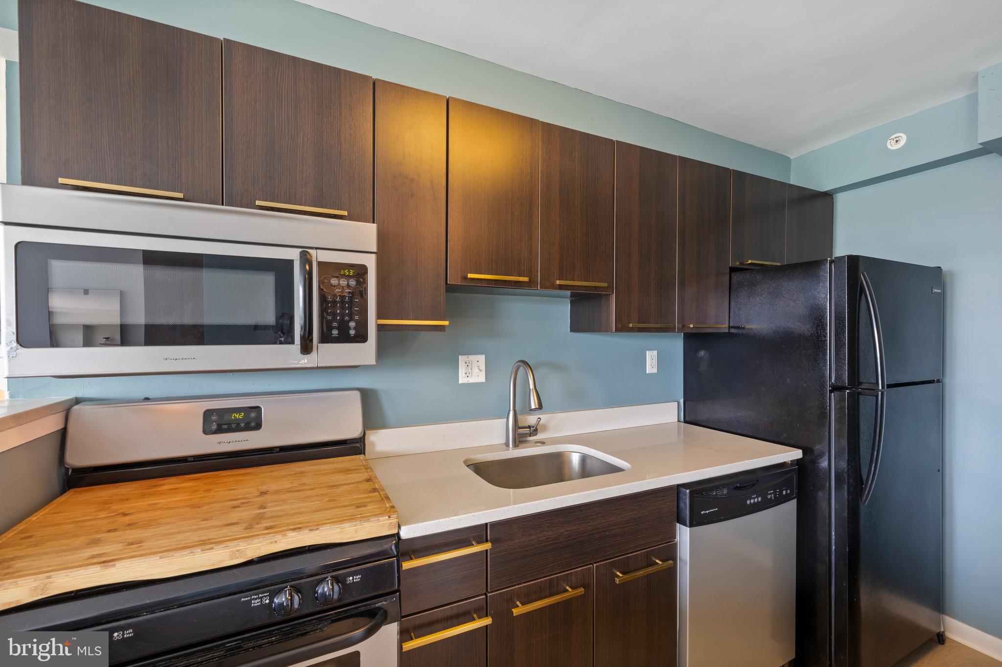 1101 3rd Street Southwest, Unit 705 Washington, DC 20024 - Photo 10 of 38 a kitchen with a sink and stainless steel appliances