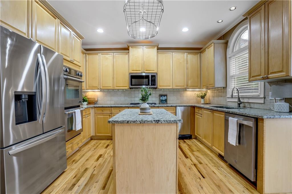 803 Rocky Ridge Court Canton, GA 30114 - Photo 11 of 74 a kitchen with stainless steel appliances granite countertop a sink a stove a refrigerator cabinets and a kitchen island