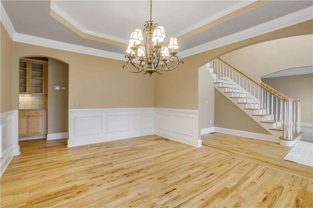 803 Rocky Ridge Court Canton, GA 30114 - Photo 21 of 74 a view of a livingroom with wooden floor and a chandelier