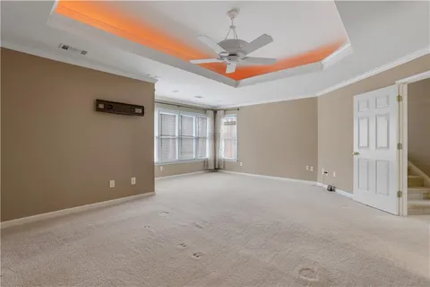 a view of an empty room with a fan