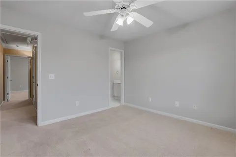 a kitchen with a refrigerator a sink and white cabinets