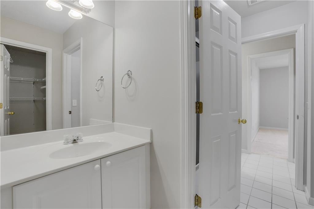 803 Rocky Ridge Court Canton, GA 30114 - Photo 45 of 74 a bathroom with a sink and a mirror