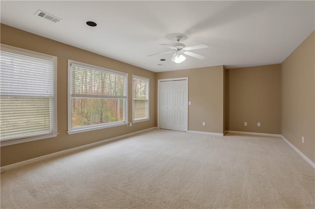 803 Rocky Ridge Court Canton, GA 30114 - Photo 46 of 74 an empty room with chandelier fan and windows