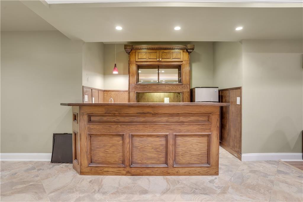 803 Rocky Ridge Court Canton, GA 30114 - Photo 54 of 74 a kitchen with kitchen island a sink stainless steel appliances and a fireplace