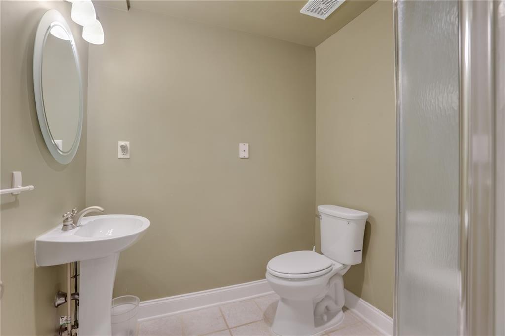 803 Rocky Ridge Court Canton, GA 30114 - Photo 59 of 74 a bathroom with a toilet sink and mirror