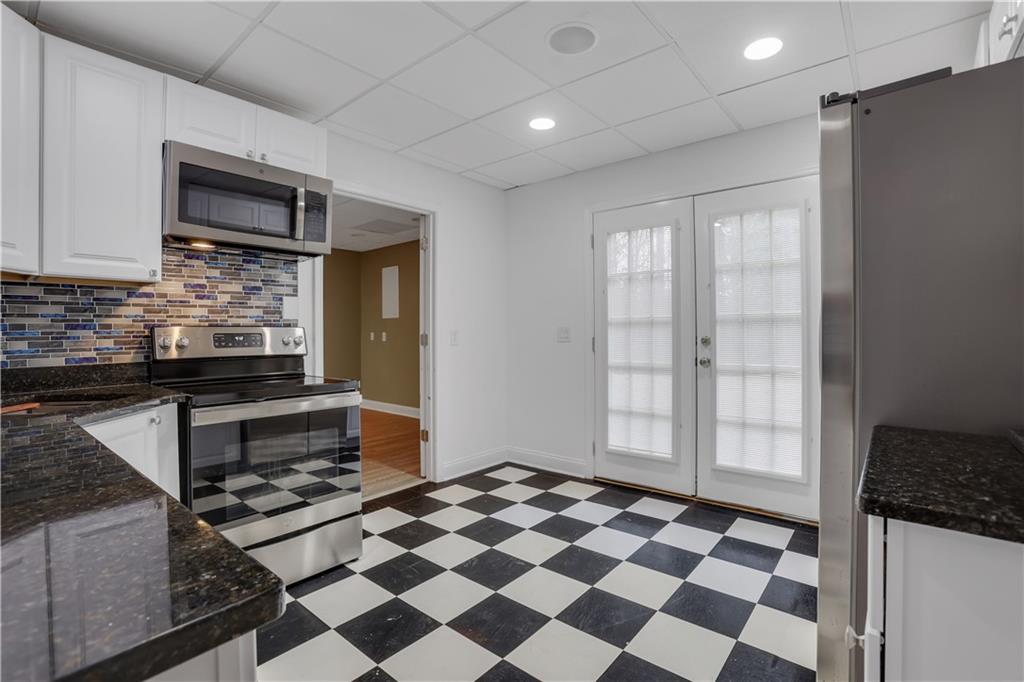 803 Rocky Ridge Court Canton, GA 30114 - Photo 60 of 74 a kitchen with granite countertop stainless steel appliances a sink and cabinets