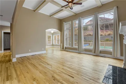 a view of a living room a room with wooden floor and furniture