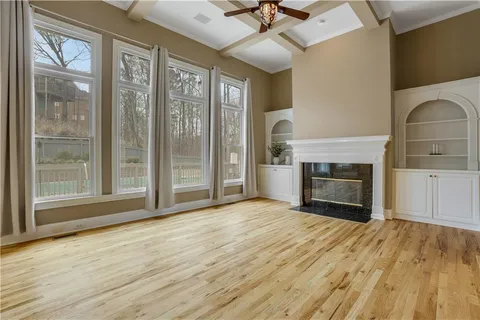 a kitchen with stainless steel appliances granite countertop a sink a stove a refrigerator cabinets and a kitchen island