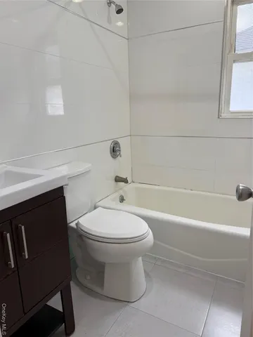 a bathroom with a toilet a sink and bathtub