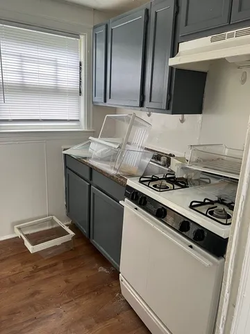 a stove top oven sitting inside of a kitchen